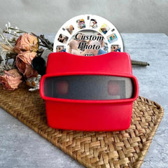imgi_63_May-include-A-red-View-Master-toy-with-a-black-viewing-area-A-white-disc-with-custom-photos-is-behind-the-toy,-with-the-words-Custom-Photo-printed-on